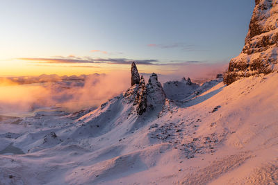 Scenic view of snow covered mountain against sky during sunset