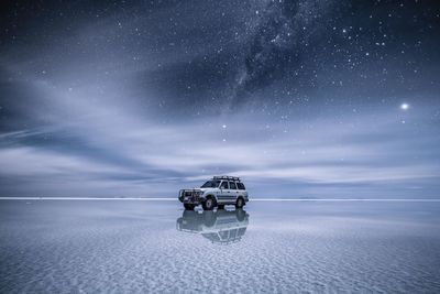 Digital composite image of sea against sky at night