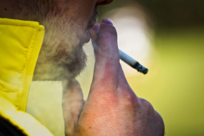 Cropped image of man smoking cigarette