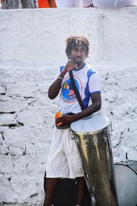 Full length of man standing against white wall