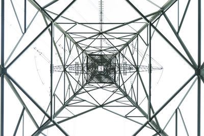 Low angle view of electricity pylon against clear sky