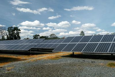 Solar panels on ground against sky