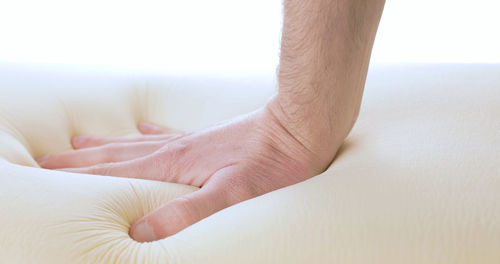 Touching and pressing a memory foam bed and pillow