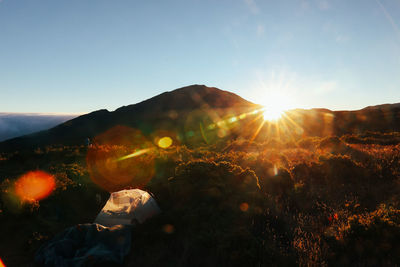 Morning sun comes over the volcano at haleakala national park with tent in the foreground, maui.