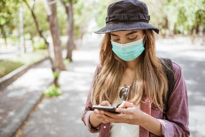 Young woman using mobile phone outdoors