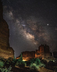 Low angle view of rock formation against sky at night