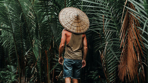 Midsection of woman standing by plants