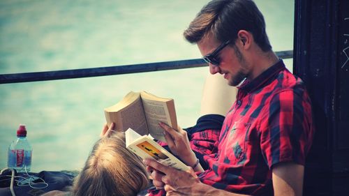 Full length of young man reading book