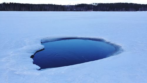 Frozen landscape against blue sky