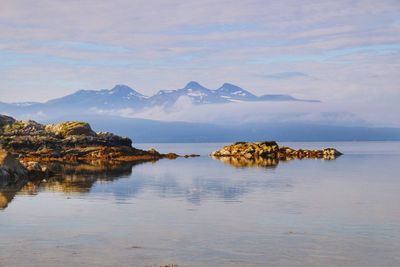 Scenic view of sea against cloudy sky