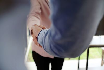 Cropped image of colleagues shaking hands