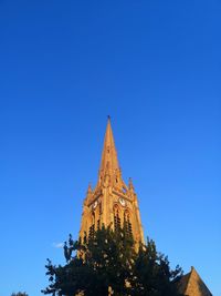 Low angle view of temple building against clear blue sky