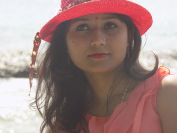 Close-up of beautiful young woman wearing hat