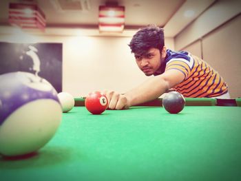 Man playing with ball on table