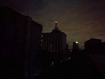 Illuminated city against sky at night