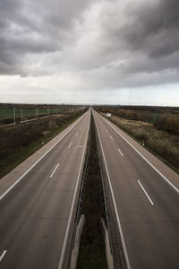 Road by landscape against sky