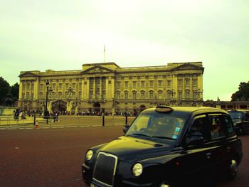 Vehicles on road against buildings in city