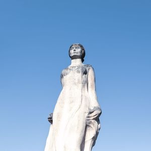 Low angle view of statue against clear blue sky