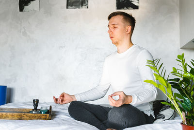 Young man sitting on floor