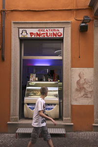 Rear view of boy standing by text