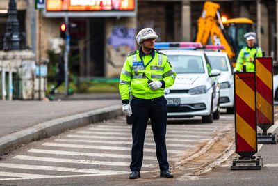 Full length of man standing on road