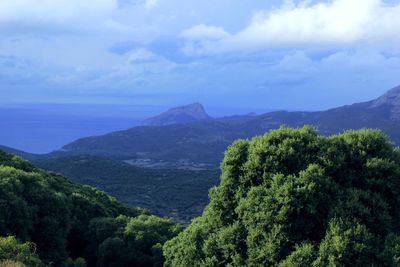 Scenic view of mountains against cloudy sky