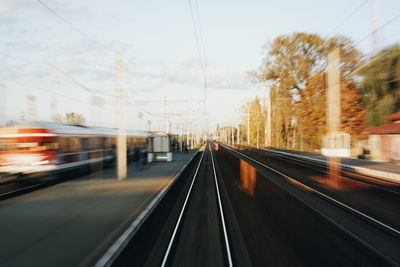 Blurred motion of train on traintrack against sky