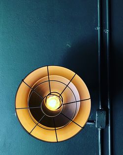 Directly below shot of illuminated light bulb hanging on ceiling