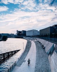 High angle view of cityscape by river against sky