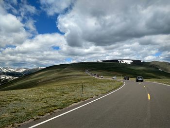 High alpine road along landscape against sky in colorado