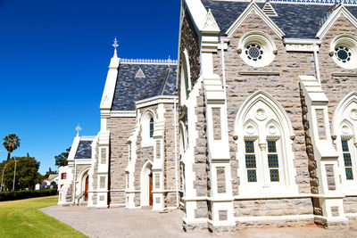 Low angle view of building against blue sky