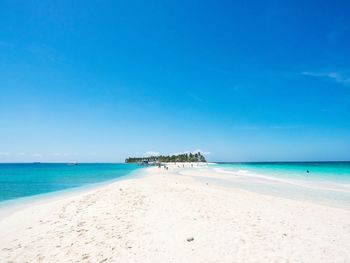 Scenic view of sea against blue sky