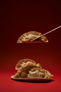 Asian dumplings on red background