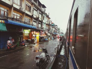 People on street amidst buildings in city