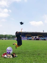 Man playing on field against sky