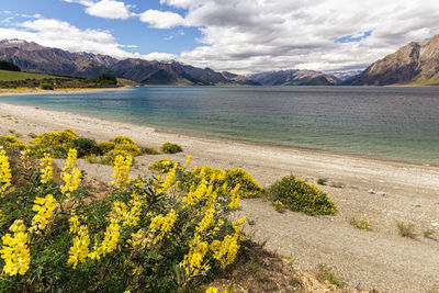 Scenic view of land and mountains against sky