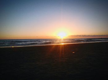 View of calm beach at sunset