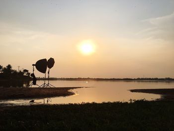 Scenic view of lake against sky during sunset