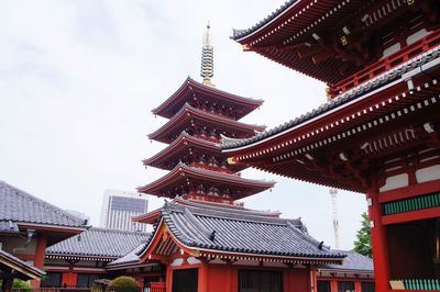 Low angle view of pagoda against cloudy sky