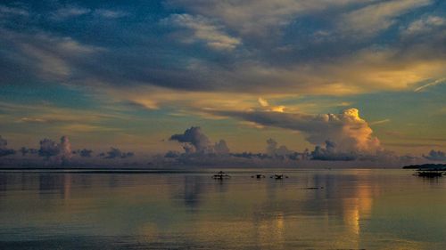 Scenic view of lake against cloudy sky