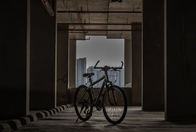 Bicycle parked by window in building