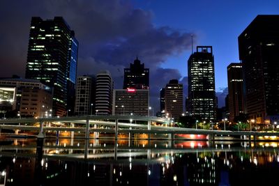 Illuminated cityscape against sky at night