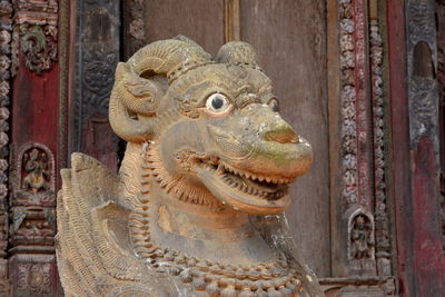Close-up of animal statue against old building