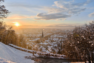 Scenic view of snow covered landscape against sky during sunset