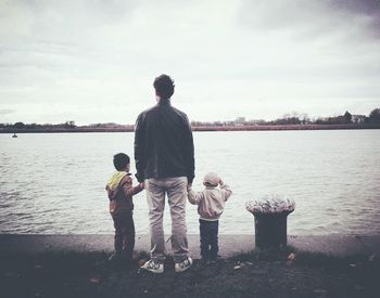 Rear view of man standing in lake