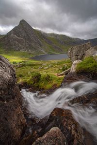 Scenic view of waterfall against sky