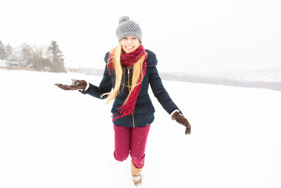 Portrait of smiling young woman on snow