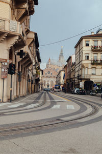 Vehicles on road along buildings