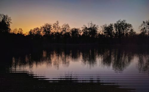 Scenic view of lake against sky at sunset