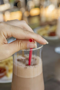 Close-up of hand holding drink